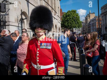 A major in the British Army's Coldstream Guards walks outside Horse Guards Parade in London for ceremonies celebrating the Queen's Platinum jubilee Stock Photo