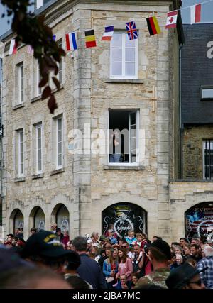 A photographer in the window snapping pictures of the crowd Stock Photo