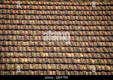 Old and weathered roof tiles creating a uniform and geometric texture typical of southeastern Spain Stock Photo