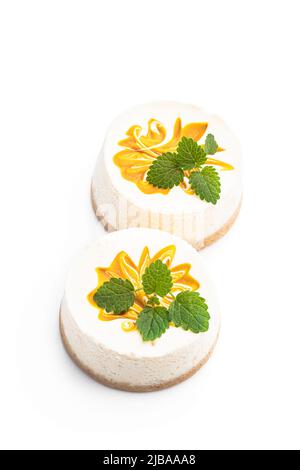 Mini  Cheesecakes decorated with yellow jam isolated on white Stock Photo