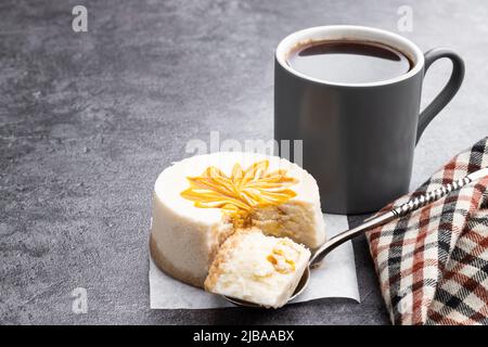 Mini  Cheesecakes decorated with yellow jam on gray background Stock Photo