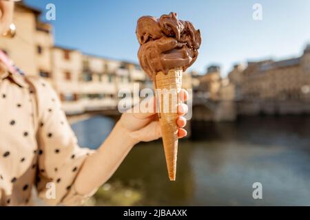 Holding chocolate ice cream on background of Florence, Italy Stock Photo