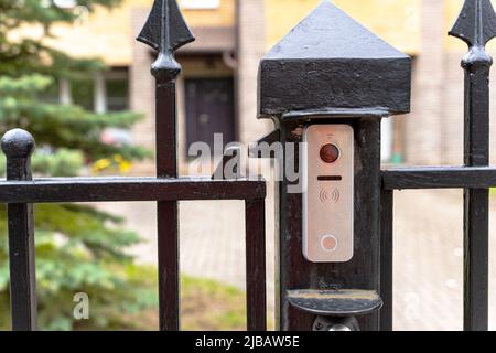 intercom panel with a video camera on the brick fence of private house Stock Photo