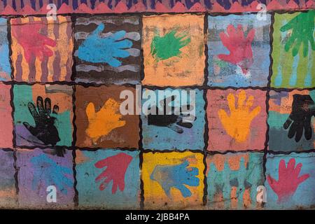 colored hand prints on wall of parking lot in downtown Albuquerque, New Mexico Stock Photo