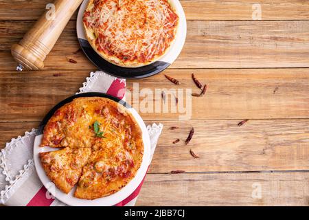 Chicago Style Deep Dish Cheese Pizza with Tomato Sauce, on wooden background Stock Photo