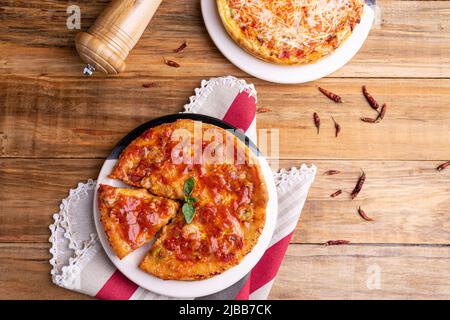 Chicago Style Deep Dish Cheese Pizza with Tomato Sauce, on wooden background Stock Photo
