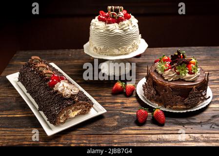 Various cakes on wooden background or table. Assortment of cakes for celebrations. Stock Photo