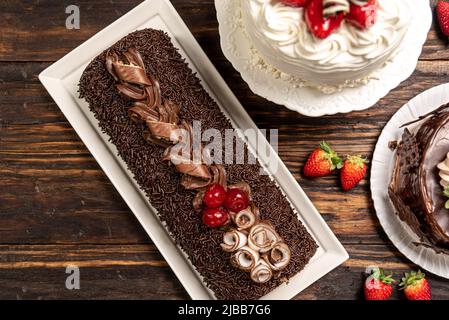 Various cakes on wooden background or table. Assortment of cakes for celebrations. Stock Photo