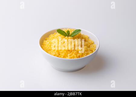 Brazilian Northeast Couscous (Cuscuz Nordestino). Maize couscous on white background Stock Photo