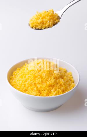 Brazilian Northeast Couscous (Cuscuz Nordestino). Maize couscous on white background Stock Photo