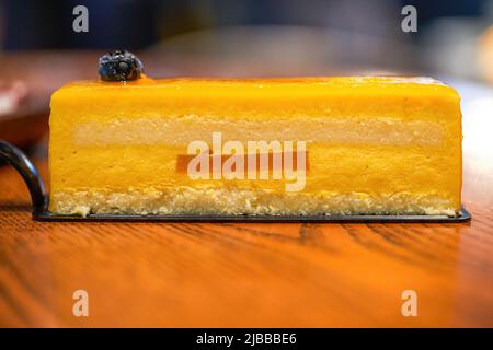 A delicious multi-layered mango mousse cake Stock Photo