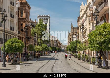 Unidentified people walking down a street in the old town, Andalusia, Seville Stock Photo