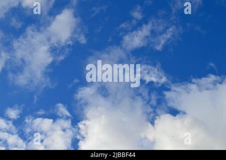 Soft white clouds floating in an azure sky Stock Photo