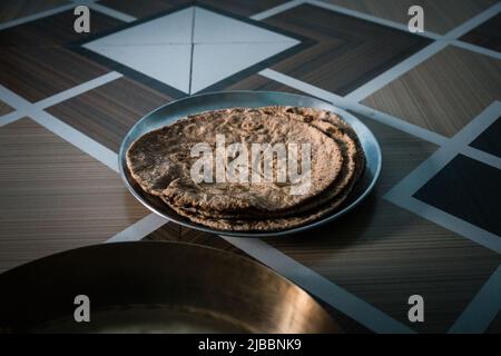 Indian Roti on traditional Indian Plate, isolated on white Stock Photo ...