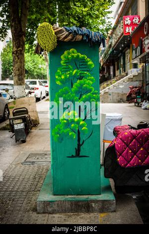 Electrical box in the street with painting of tree Stock Photo