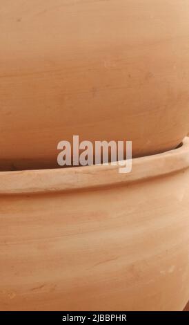 Vertical image of close up of large stacked terracotta pots Stock Photo