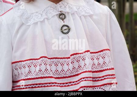 Close-up of a fragment of an Estonian folk costume. Detail of woman dress. Summer Event. Stock Photo