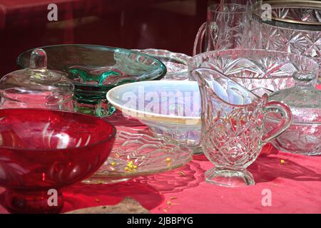 Vintage lead crystal punch bowl and cups on a wooden table at an antique store. Stock Photo