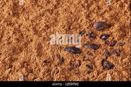 Cocoa powder background with cacao beans Stock Photo