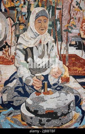 Mosaic Art Depicting Lady Using Grinding Wheel Stock Photo