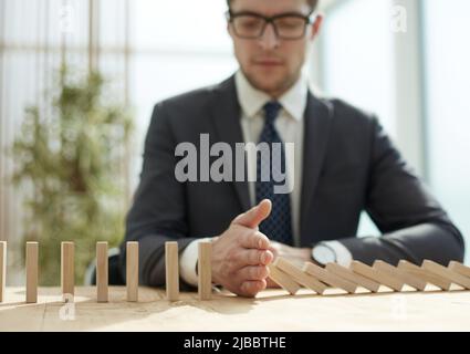 Businessman with dominoes in the office. concept business risk Stock Photo
