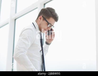 man talking on phone and smiling in office Stock Photo