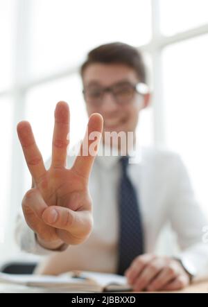 Young businessman man showing number three with fingers on hand Stock Photo
