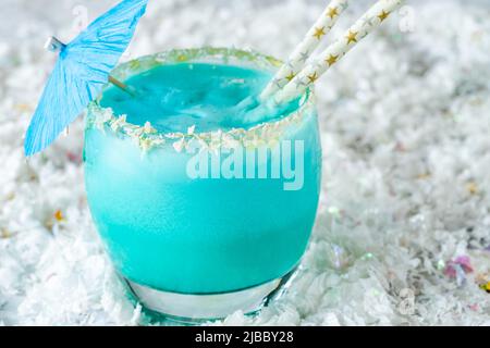 Jack Frost Christmas Cocktail with coconut rum, blue curacao, coconut cream and pineapple juice Stock Photo