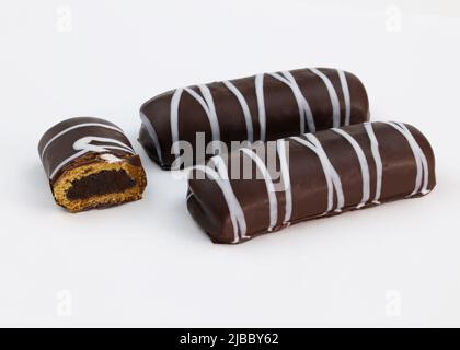 Gingerbread in chocolate glaze with jam. Cookies covered in dark chocolate. Gingerbread with filling on a white background close-up. Stock Photo