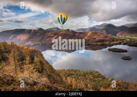 Digital composite image of hot air balloons over Epic landscape Autumn image of view from Walla Crag in Lake District, over Derwentwater looking towar Stock Photo