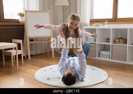 Father lifts on arms his daughter have fun at home Stock Photo