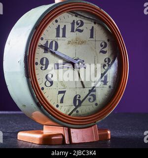 Rusty Broken Clock Dirty old broken rusty alarm clock. Broken dial. Red body violet ...