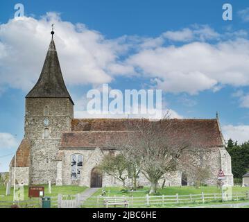 St Mary the Virgin church was built by the Normans in the 12th century and stands in the heart of St Mary in the Marsh, a village in Romney Marsh. Stock Photo