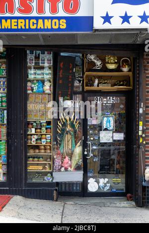 The exterior of EL RINCONSITO who sell Central American products and have a statue of Virgin Mary with a donation slot in their window. Stock Photo