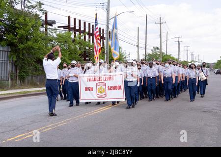 The Francis Lewis High School JrOTC marching in the College Point, Queens Memorial Day Parade. A diverse group of teens with most wearing masks. Stock Photo