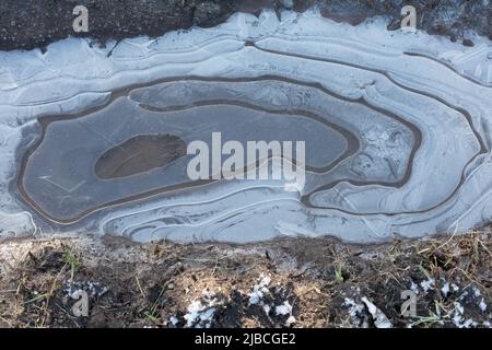 Natural Patterns; Circular ice patterns in frozen water puddles in winter Stock Photo