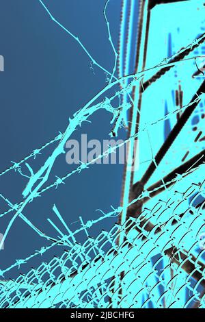 Razor sharp barbed wire fence protecting the industrial area in a bright blue color film negative. Stock Photo