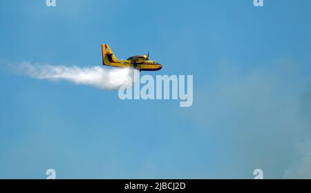 Athens, Greece, June 4, 2022: A firefighting Canadair CL-215 aircraft operates in Hymettus mount wildfire near Glyfada suburb of Athens. Stock Photo