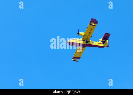 Athens, Greece, June 4, 2022: A firefighting Canadair CL-415 aircraft operates in Hymettus mount wildfire near Glyfada suburb of Athens. Stock Photo