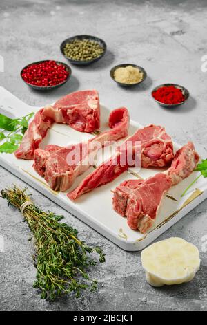 Raw boneless rack of lamb on wooden cutting board, Stock Photo