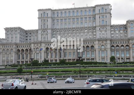 NATO, Romanian & EU flags in front of the House of the people in Bucharest, Romania; the 2nd largest building in the world. Seat of the parliament Stock Photo