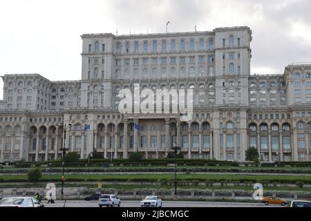 NATO, Romanian & EU flags in front of the House of the people in Bucharest, Romania; the 2nd largest building in the world. Seat of the parliament Stock Photo