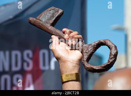 Protester holding key at the End Apartheid - Free Palestine protest in London. The keys symbolise homes stolen from Palestinians by Israel since 1948. Stock Photo