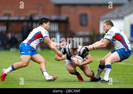 Hull FC's Connor Wynne (centre) is tackled during the Betfred Super League match at The Be Well Support Stadium, Wakefield. Picture date: Sunday June 5, 2022. Stock Photo