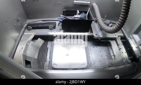 Empty Working Chamber of 3D Printer for Metal Close-up. Laser Sintering Machine for Metal. Additive New Modern Progressive Technology. Metal 3D Printer Inside. Clean Working Chamber Metal 3D Printer Stock Photo