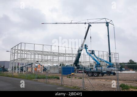 New building of an industrial hall in the Netherlands with metal skeleton rising. Stock Photo