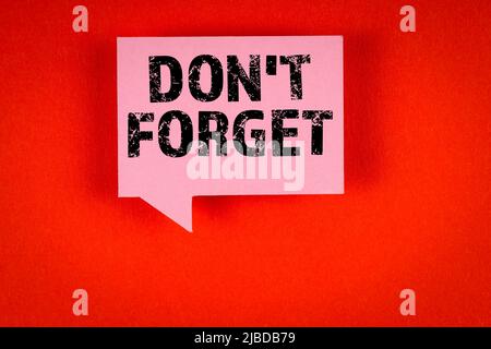 Don't Forget. Pink speech bubble on a red background. Stock Photo