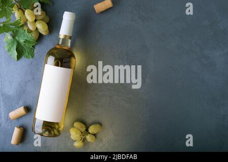 https://l450v.alamy.com/450v/2jbdfab/a-bottle-of-white-wine-with-a-label-grapes-cork-and-bottle-opener-top-view-2jbdfab.jpg