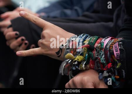 Rhineland-Palatinate, Nürburg: 05 June 2022, A rock fan wears dozens of festival bracelets on his wrist at the 'Rock am Ring' festival. The festival is sold out with 90,000 visitors. Photo: Thomas Frey/dpa Stock Photo