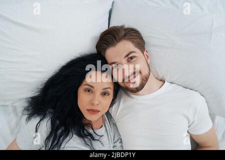 Man and his beloved lady resting in bedroom Stock Photo